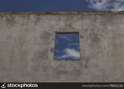 Square window on old ruined wall on the roof of Doxi Stracca Fontana Palace about 1760 A.D. in the old town of Gallipoli (Le)) in the southern Italy