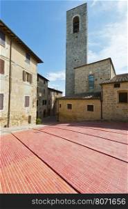 Square with Bell Tower in the Medieval City of Gimignano in Italy