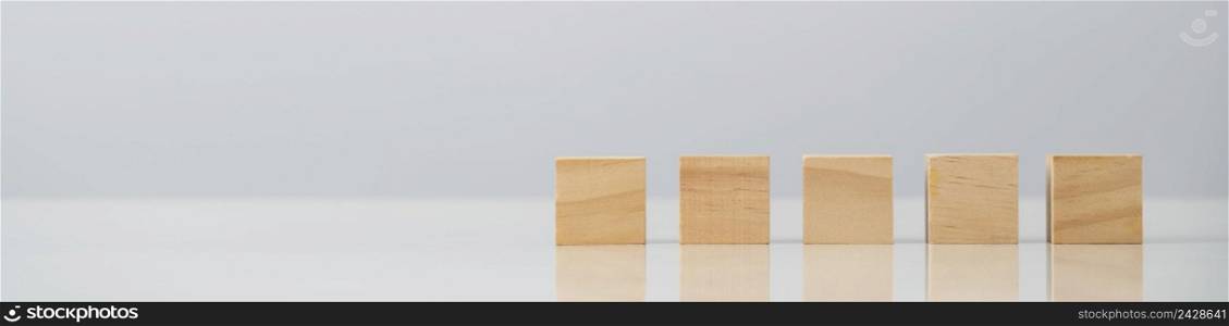 Square wooden blocks on table , blank wooden cubes on table with copy space for text or symbols is used make to banner on wooden block