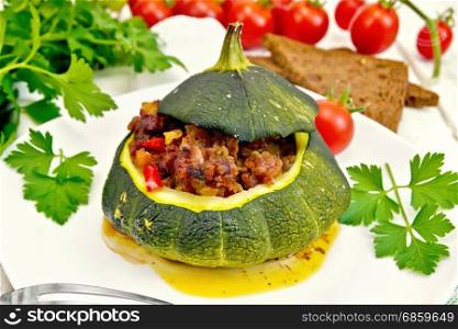 Squash green stuffed with meat, tomatoes and peppers in the dish, bread, garlic and parsley on a wooden board background