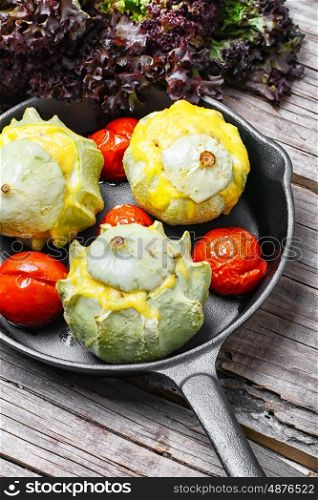 squash in the pan. squash stuffed with cheese and tomatoes in cast iron skillet