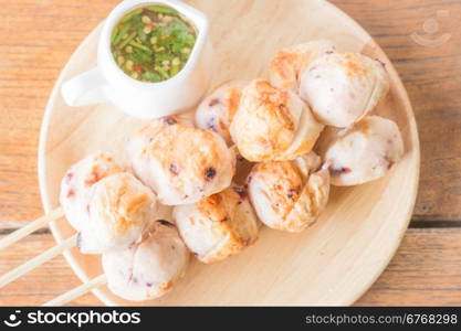 Squid grilled ball on wooden plate, stock photo