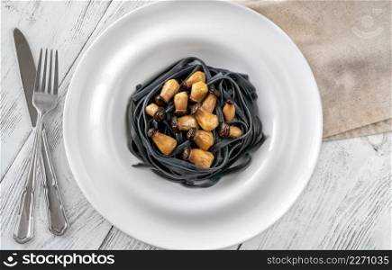 Squid ink linguine pasta with baby mushrooms