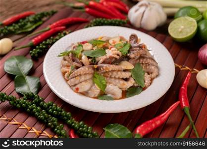 Squid salad with coriander, chopped green onion, garlic and corn on the plate