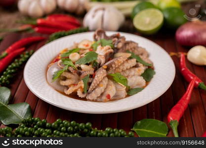 Squid salad with coriander, chopped green onion, garlic and corn on the plate