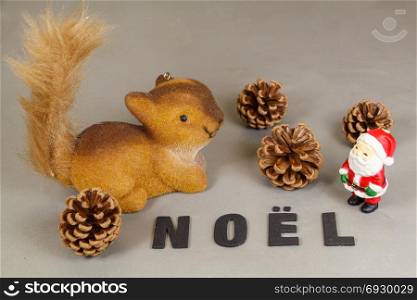 Squirrel and Santa Claus figurine, pine cones and the word Christmas in french