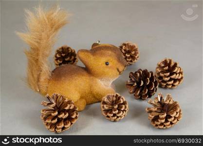 Squirrel figurine and pine cones as decoration for Christmas