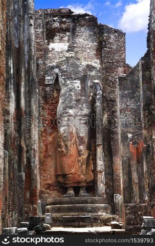 Sri Lanka travel and landmarks - ancient city of Polonnaruwa, UNESCO World Heritage Site. Buddha statue carved in the rock, Lankatilaka Vihara temple. ancient city Polonnaruwa, Sri Lanka.