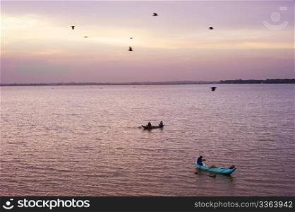 Sri lankan fishermans catching fish at sunset