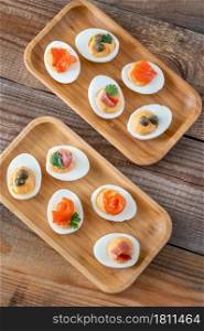 Sriracha deviled eggs with different toppings