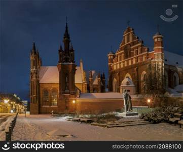 St. Anne&rsquo;s and St. Bernardino Churches at winter night. Landmark in Vilnius, The capital of Lithuania