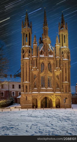 St. Anne&rsquo;s church and star tracks, at winter night. Landmark in Vilnius, The capital of Lithuania