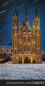 St. Anne&rsquo;s church and star tracks, at winter night. Landmark in Vilnius, The capital of Lithuania