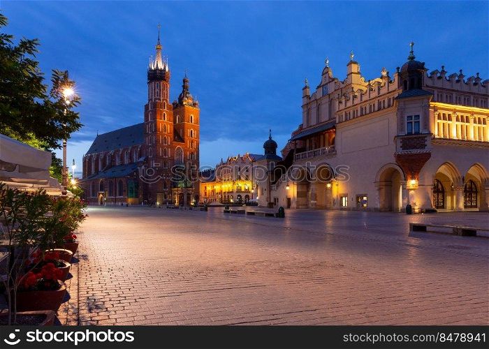 St. Mary’s Church on the market square in night lighting. Krakow. Poland.. Krakow. St. Mary’s Church and market square at dawn.