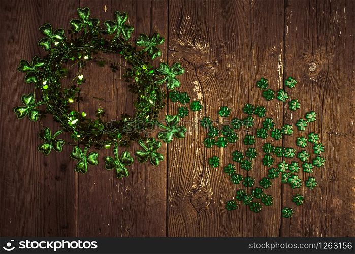 St. Patricks Day composition. Shamrock wreath, shamrocks on an old rustic wood background. St.Patrick&rsquo;s day holiday symbol. Top view, copy space.