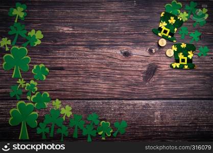 St Patricks day, golden coins, festive hat and green Shamrocks on wooden