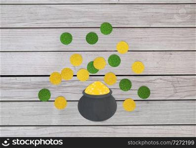 st patricks day, holidays and celebration concept - pot of gold and coins made of paper on grey wooden boards background. pot of gold and coins for st patricks day