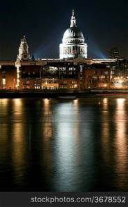 St Paul&acute;s Cathedral and Millennium Bridge in London at night with reflections in River Thames with vibrant colors and floodlights