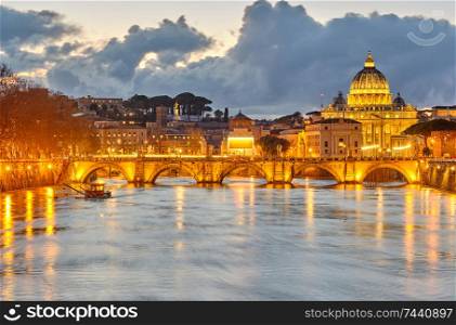 St. Peter&rsquo;s cathedral and Tiber river with high water at evening. Saint Peter Basilica in Vatican city with Saint Angelo Bridge in Rome, Italy