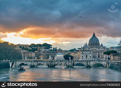 St. Peter&rsquo;s cathedral and Tiber river with high water at evening with dramatic sunset sky. Saint Peter Basilica in Vatican city with Saint Angelo Bridge in Rome, Italy