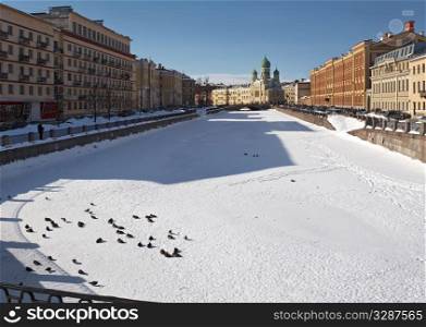 St.Petersburg city. River covered by ice with church and houses