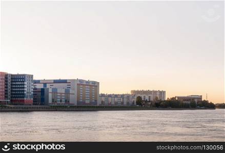 St. Petersburg, Russia - September 5, 2017:   Case of industrial concern out on the river. Evening shot