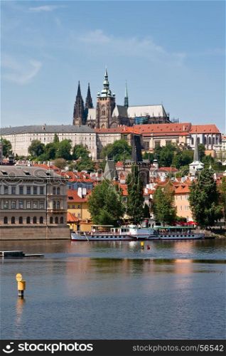St. Vitus Cathedral on the hill, district Hradcany, Vltava river and ships at berth. Prague