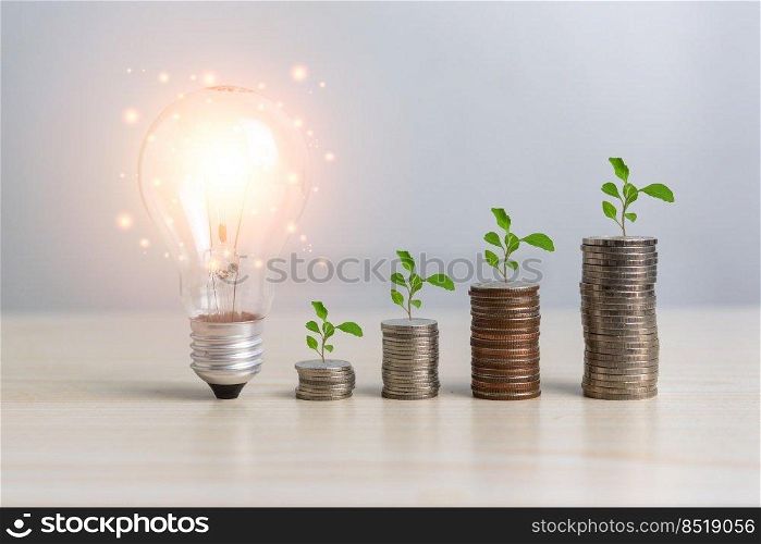 Stack money coin and tree bulb light with business graph finance economy bank and chart investment wealth accounting development concept.