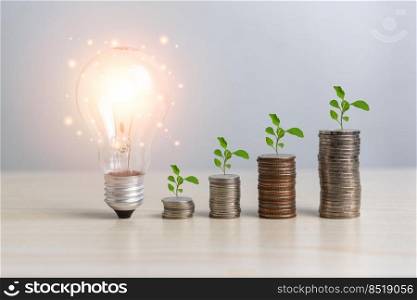 Stack money coin and tree bulb light with business graph finance economy bank and chart investment wealth accounting development concept.