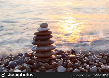 Stack of a stones on the beach . Stack of a stones on the sea beach at sunrise