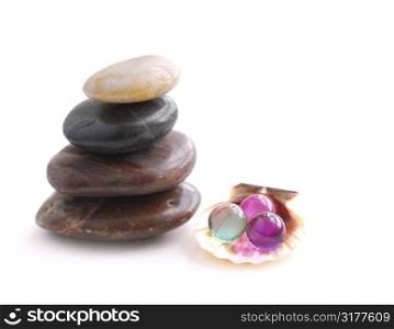 Stack of balanced stones with bath beads isolated on white background