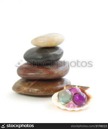 Stack of balanced stones with bath beads isolated on white background