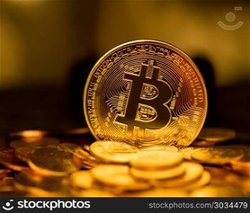 Stack of bitcoins with gold background. Stack of bit coins or bitcoin on gold background to illustrate blockchain and cyber currency. Stack of bitcoins with gold background