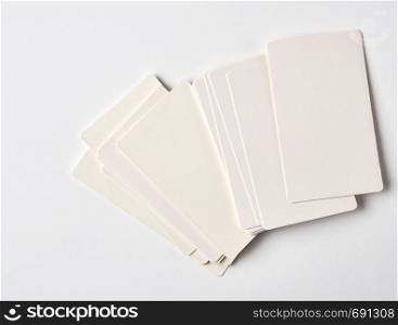 stack of blank rectangular paper white business cards on a white background, top view