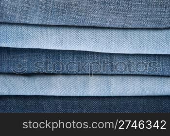 stack of blue jeans as a background or texture