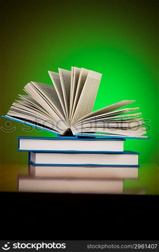 Stack of books against gradient background