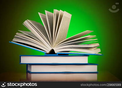 Stack of books against gradient background