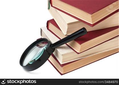 stack of books and magnifying glass isolated on white