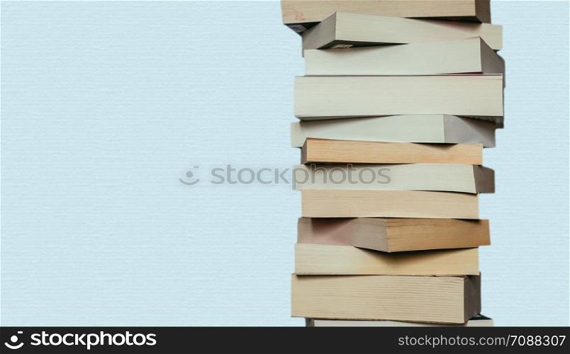 Stack of books before blue background