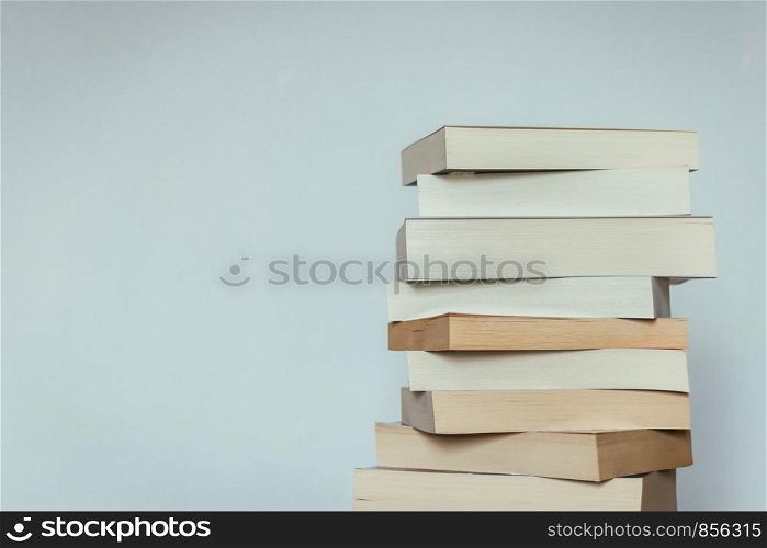 Stack of books before grey background