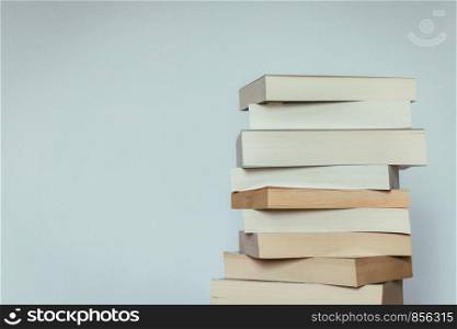 Stack of books before grey background