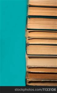 stack of books on green background