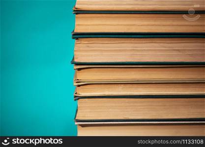 stack of books on green background