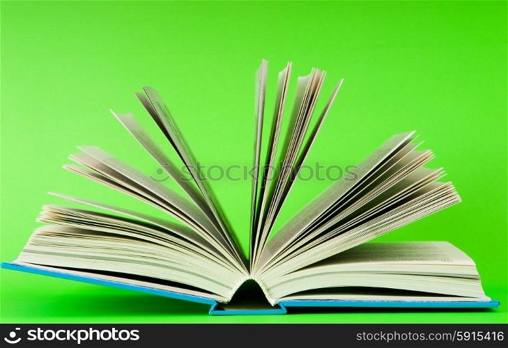 Stack of books on the color background