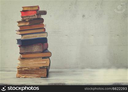 stack of books on white wooden background, retro toned. set of books
