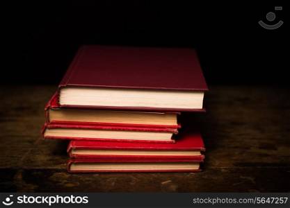Stack of books on wooden surface