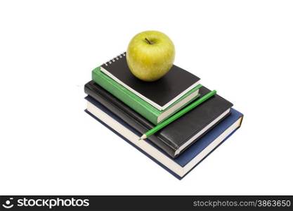 Stack of books with green apple on white background
