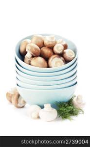 Stack of bowls and Fresh mushrooms over white