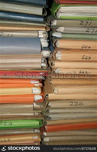 Stack of carton dossiers in many different colors