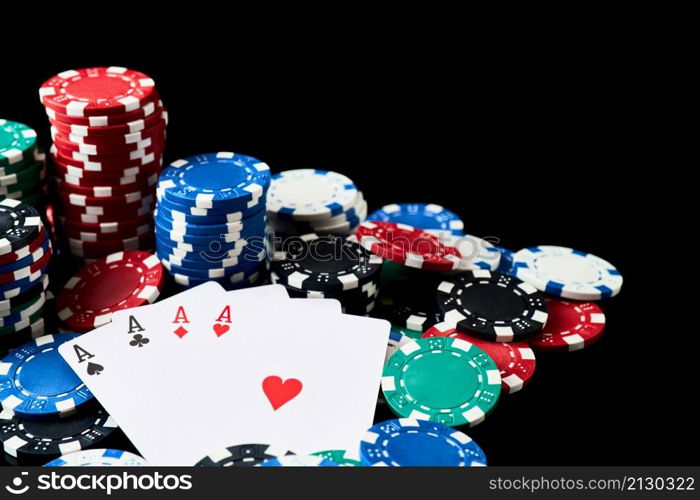 Stack of Casino gambling chips and cards isolated on black reflective background.. Stack of Casino gambling chips and cards isolated on black reflective background